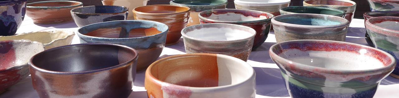 Some handmade ceramic bowls on table outside